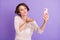 Photo of adorable coquettish lady take selfie arm palm send air kiss  on violet color background