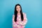 Photo of adorable dreamt young woman wear pink sweater arms folded looking empty space isolated blue color background