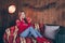 Photo of adorable funny mature lady wear red pullover smiling talking modern gadget drinking christmas beverage indoors