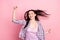 Photo of adorable happy nice young woman wind blow hair winner good mood isolated on pastel pink color background