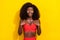 Photo of adorable impressed african lady dressed red sexy clothes smiling arms chest isolated yellow color background