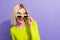 Photo of adorable optimistic girl wear stylish yellow shirt touching glasses look at offer empty space isolated on