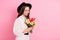 Photo of adorable pretty young woman dressed white clothes cap holding tulip bunch empty space isolated pink color