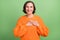 Photo of adorable senior woman arms on chest promise honest grateful isolated over green color background