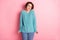 Photo of adorable young lady hold hands sleeves look camera wear blue pullover jeans isolated pink background