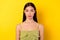 Photo of adorable young malaysian lady calm face wear singlet isolated on bright yellow color background