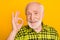 Photo of aged man happy positive smile show okay sign sign deal done alright advert isolated over yellow color