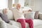 Photo of aged man pensioner sit couch home rest relax look watch tv cinema switch channel remote controller