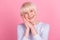 Photo of aged woman hands touch cheek admire dream lovely good mood isolated over pink color background