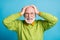 Photo of aggressive retired old man hands head mad look wear glasses green sweater isolated blue color background