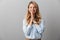 Photo of alluring blond businesswoman with long curly hair smiling and praying with palms together