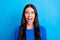 Photo of amazed attractive happy young woman shocked sale shopping isolated on blue color background