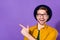 Photo of amazed cheerful young man point finger empty space shocked sale isolated on violet color background
