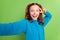 Photo of amazed excited happy little girl make selfie show v-sign face smile isolated on green color background
