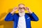 Photo of amazed happy excited old man wear glasses good mood sale isolated on yellow color background