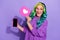 Photo of amazed lady vivid haircut hold smart phone display heart icon many followers like ad isolated over purple color