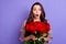 Photo of amazed shocked young lady hold flowers roses present valentine day  on purple color background