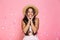 Photo of amazed woman 20s wearing straw hat laughing while stand