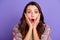 Photo of amazed young shocked woman hold hands cheeks news information  on violet color background