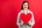 Photo of amazing lady with large paper heart wear knitted pullover isolated red background