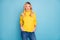 Photo of amazing pretty blond lady toothy smiling good mood holding hands in pockets wear warm knitted yellow jumper