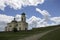 Photo of ancient Khotyn church near the castle in Ukraine at the day time in summer under extremely fluffy clouds