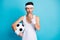 Photo of angry soccer player hold ball blow whistle wear white tank-top isolated over blue color background