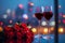 Photo Anniversary elegance red wine glasses, red roses, colorful city lights