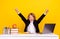 Photo of astonished child sit desk scream celebrate victory raise fist wear uniform isolated yellow color background