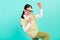 Photo of astonished funny school girl celebrate victory wear specs green top cardigan  teal color background