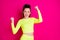Photo of astonished funny young woman stand fists up yell dress sport wear isolated on vivid pink color background