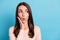 Photo of astonished girl touch hand face look empty space with open mouth isolated over blue pastel color background