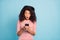 Photo of astonished grimacing black youngster holding telephone with hands staring in wearing striped t-shirt isolated