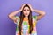 Photo of astonished speechless girl long hairstyle dressed flower print t-shirt hold palms on head  on violet