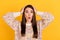 Photo of astonished young woman hold hands head shock news negative isolated on yellow color background