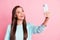 Photo of attractive beautiful amazed young woman hold phone take video selfie isolated on pastel shine pink color