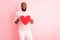 Photo of attractive dark skin guy hold red paper heart affectionate boyfriend inviting girlfriend romantic date wear