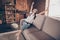 Photo of attractive drowsy young woman white t-shirt sitting couch rising hands arms yawning indoors apartment room