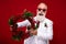 Photo of attractive funky age gentleman wear new year costume dark eyewear holding wreath isolated red color background