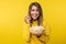 Photo of attractive lady holds plate of popcorn, with smile. Wears casual yellow hoody, isolated yellow color background