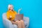 Photo of attractive pensioner woman armchair talk video call recruiter wear trendy yellow silky clothes isolated on blue