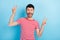 Photo of attractive positive cool guy raise hands make v-signs peace isolated on pastel blue color background