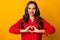 Photo of attractive pretty wavy lady hold hands fingers making heart figure symbol romantic mood lovers day wear red