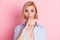 Photo of attractive silent young woman hold hand finger lips isolated on pastel pink color background