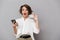 Photo of attractive woman 20s holding mobile phone and credit ca