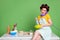 Photo of attractive young lady cooking cheerful sitting table kitchen curlers hair charming housewife talk cable