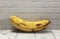 Photo of a banana on a wooden patterned table