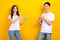 Photo banner of two smiling positive people students directing fingers like their outfits looking stylish isolated on