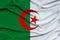 Photo of beautiful colored national flag of modern african state algeria on textured fabric, concept of tourism, emigration,