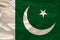 Photo of the beautiful colored national flag of Pakistan state on a textured fabric, concept of tourism, economics and politics,